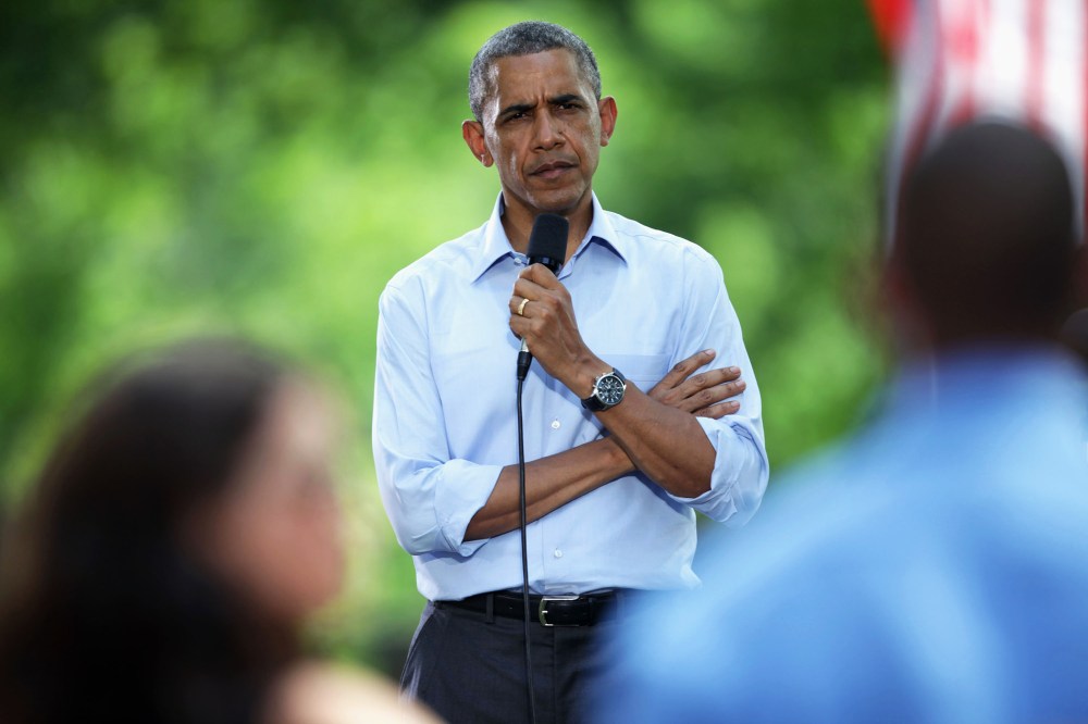 President Barack Obama listens to a speaker at an invite-only town hall meeting on Thursday, June 26, 2014, at Minnehaha Park in Minneapolis, Minn.