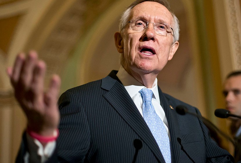 Senate Majority Leader Harry Reid of Nev. gestures as he speaks with reporters on Capitol in Washington, Tuesday, July 9, 2013 (Photo by J. Scott Applewhite/AP)