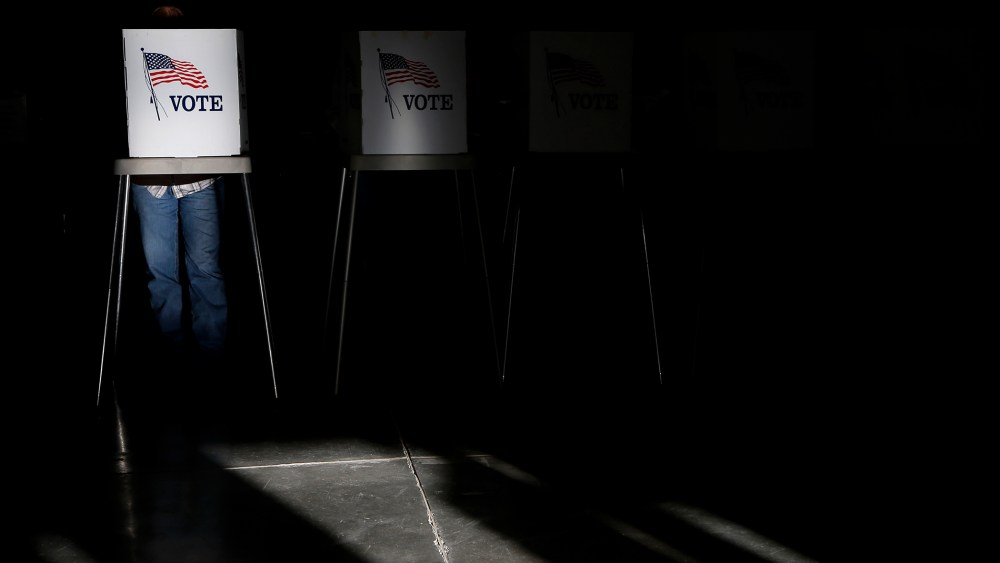 Voting booths are illuminated by sunlight as voters cast their ballots at a polling place, Nov. 6, 2012, in Billings, Mont.