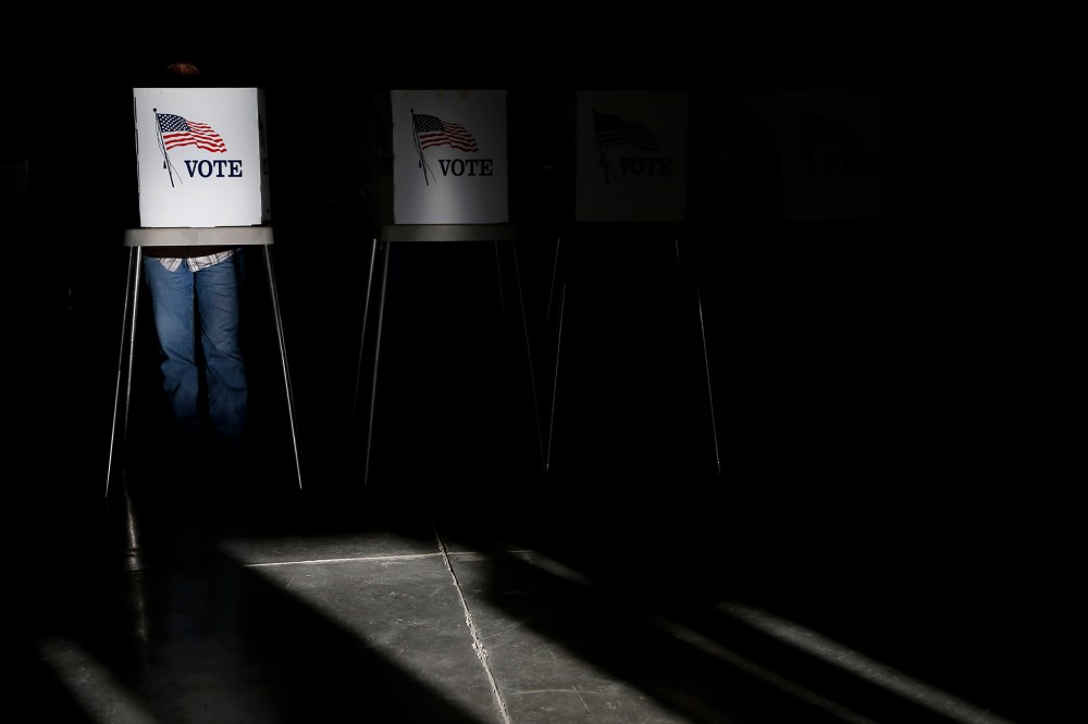 Voting booths are illuminated by sunlight as voters cast their ballots at a polling place, Nov. 6, 2012, in Billings, Mont.
