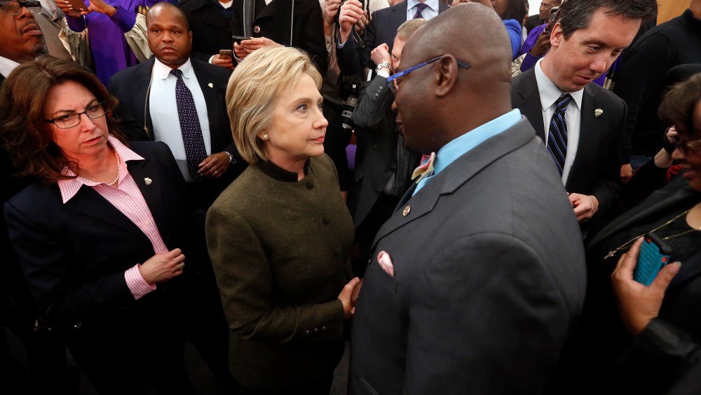 Democratic presidential candidate Hillary Clinton speaks with an audience member at the House Of Prayer Missionary Baptist Church, Feb. 7, 2016 in Flint, Mich. (Photo by Paul Sancya/AP)