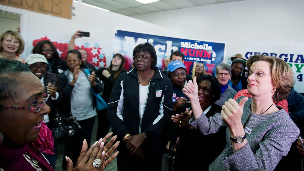 Georgia U.S. Senate Democratic candidate Michelle Nunn, right, greets supporters at a campaign field office, Monday, Nov. 3, 2014, in Decatur, Ga. (Photo by David Goldman/AP)