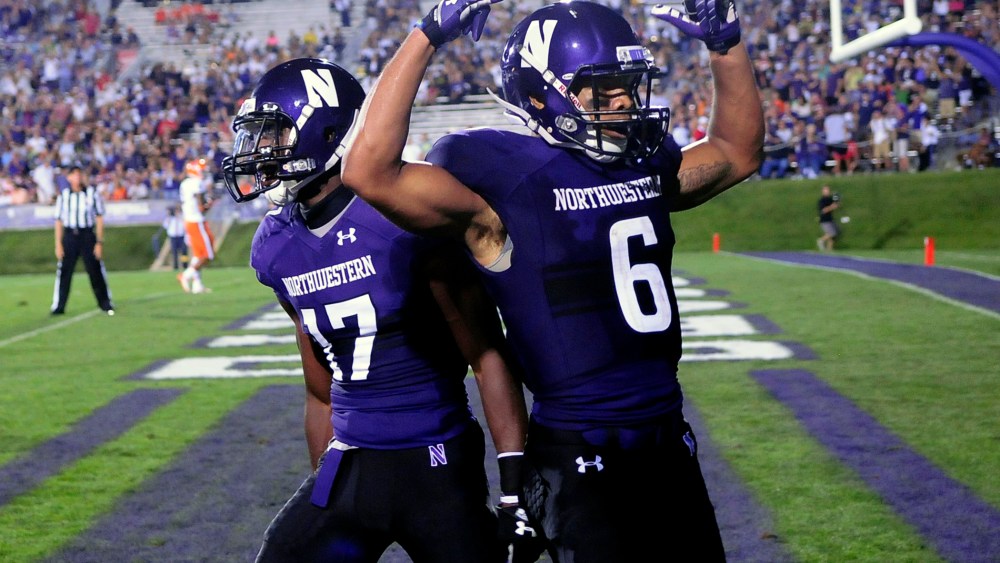 Northwestern players celebrate a touchdown during a game against Syracuse University in Evanston, Ill, Sept.7, 2013.