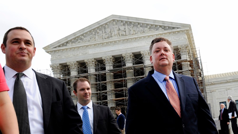 Shaun McCutcheon (R) leaves the Supreme Court in Washington, Tuesday, Oct. 8, 2013, after the court's hearing on campaign finance.