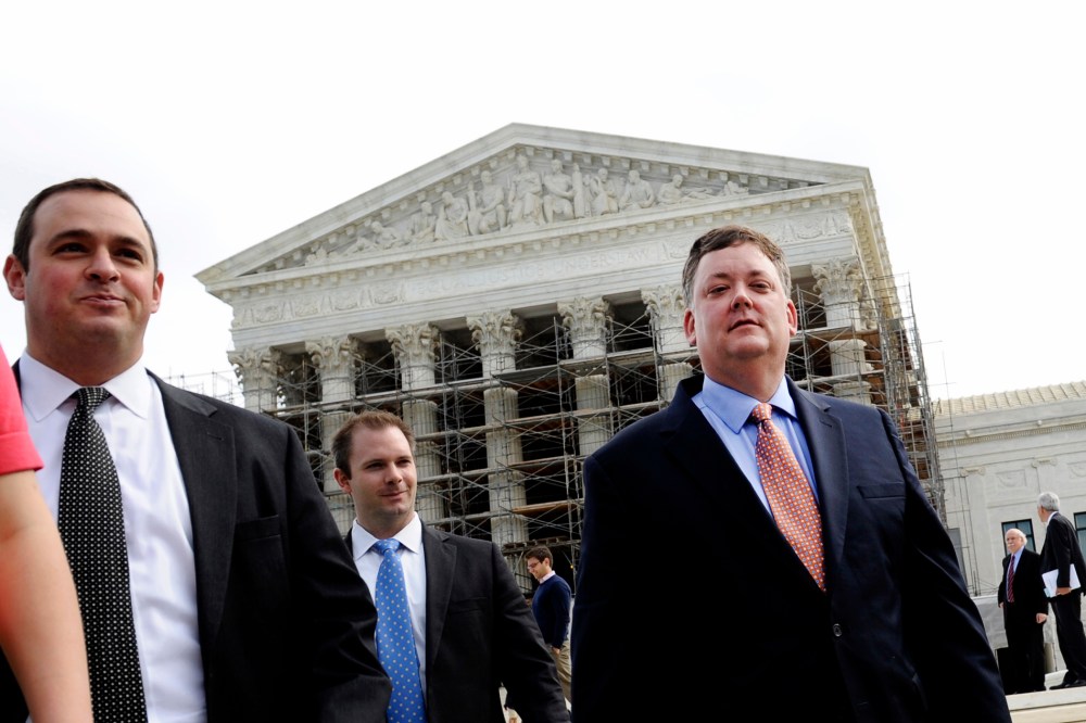 Shaun McCutcheon (R) leaves the Supreme Court in Washington, Tuesday, Oct. 8, 2013, after the court's hearing on campaign finance.