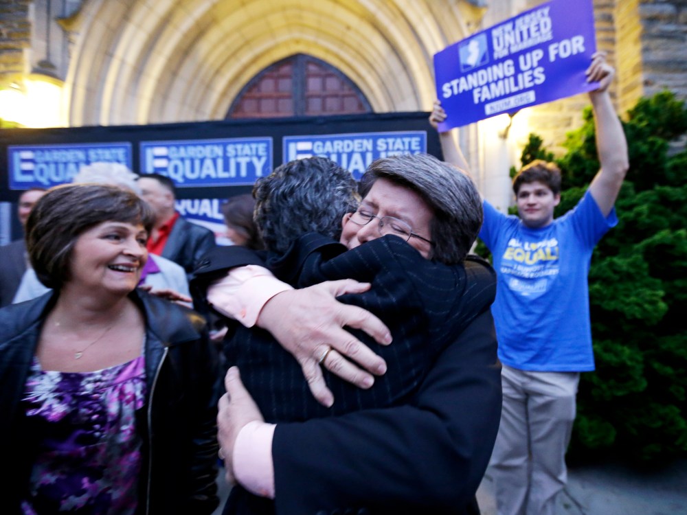 Cindy Meneghin hugs her attorney during a rally at Garden State Equality in Montclair, N.J., hours after same-sex marriages were made legal by a state judge, Friday, Sept. 27, 2013.