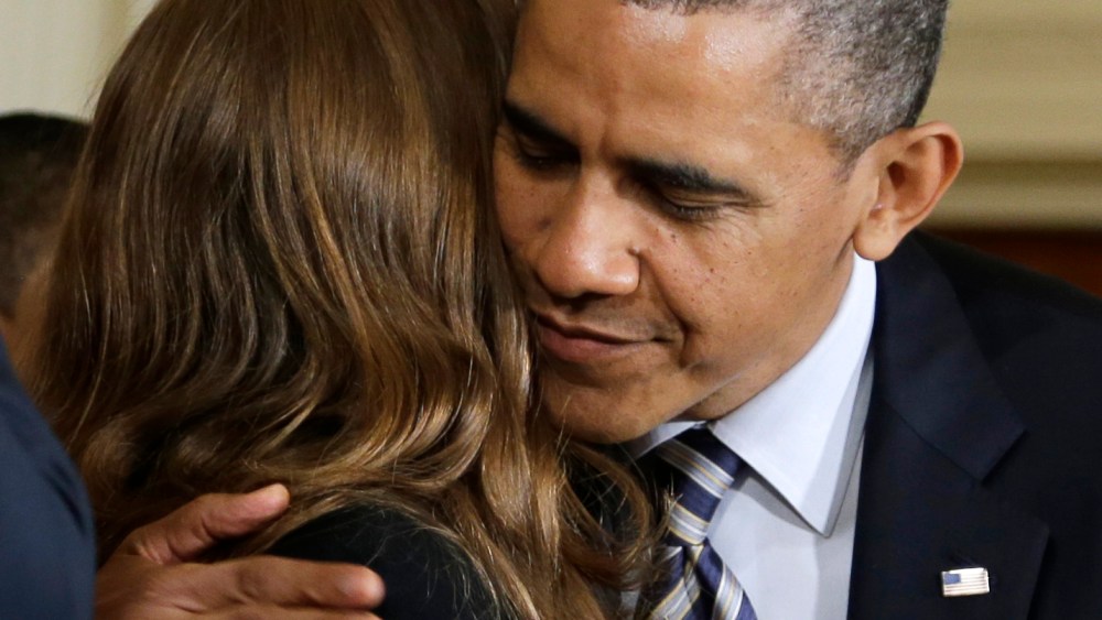 President Barack Obama hugs Katerina Rodgaard, a Maryland dance instructor who knew one of the victims of the Virginia Tech shootings, after she introduced him in the East Room of the White House in Washington, Thursday, March 28, 2013, where the...