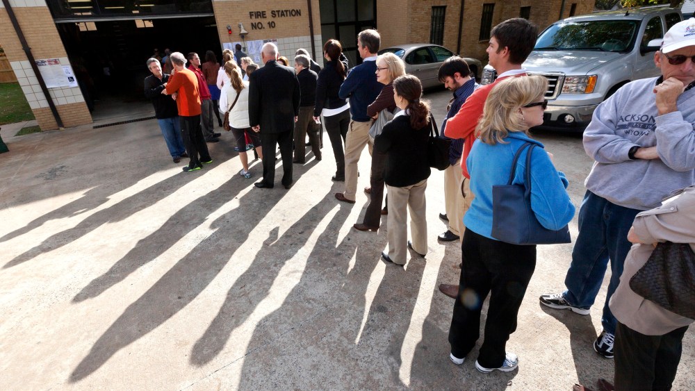 Voters wait in line outside a fire station being used as a polling place in Little Rock, Ark., on Nov. 6, 2012.