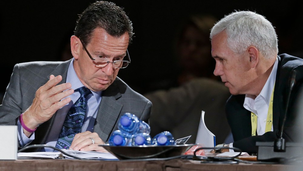 Connecticut Gov. Dan Malloy talks with Indiana Gov. Mike Pence during a meeting on jobs and education at the National Governors Association convention on July 12, 2014, in Nashville, Tenn. (Photo by Mark Humphrey/AP)