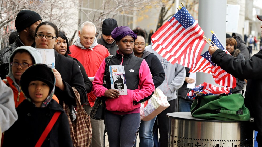 Voters wait in line outside the Cuyahoga County Board of Elections in Cleveland on the final day of early voting Monday, Nov. 5, 2012.