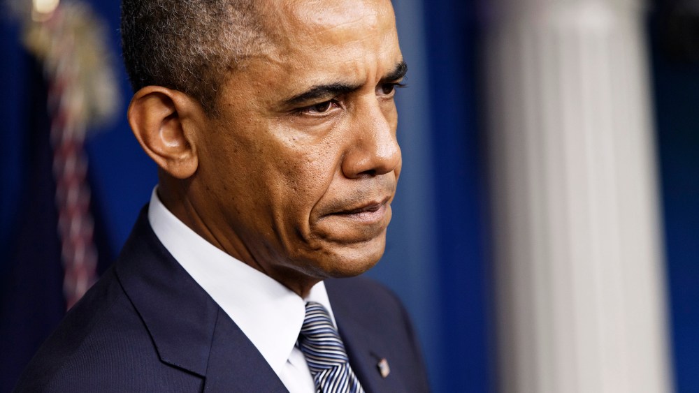 President Barack Obama pauses while speaking in the Brady Press Briefing Room of the White House on July 18, 2014 in Washington, D.C. (Photo by J. Scott Applewhite/AP)