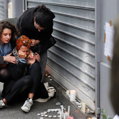 A woman is comforted by others outside the Carillon cafe and the Petit Cambodge restaurant in Paris, Nov. 14, 2015, a day after over 120 people were killed in a series of attacks in Paris. (Photo by Jerome Delay/AP)