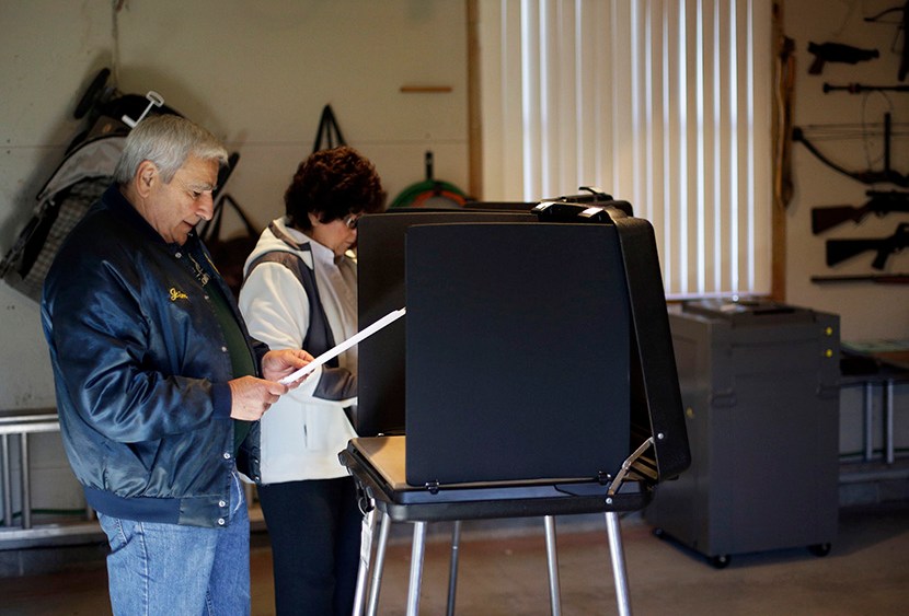 Gene Dovin, left, and his wife Bea Dovin, both of Forest City casts their votes at a polling place inside a residential garage, Tuesday, Nov. 6, 2012, in Forest City, Pa. (Photo by Matt Slocum/AP)