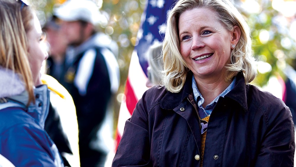 Liz Cheney talks with Laramie residents prior to the start of the University of Wyoming homecoming parade, Oct. 12, 2013.