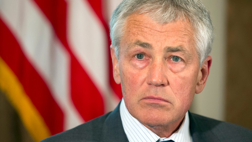Defense Secretary Chuck Hagel listens as President Barack Obama speaks to media during a meeting with Hagel, Joint Chiefs Chairman Gen. Martin Dempsey, and the service secretaries, service chiefs, and senior enlisted advisers to discuss sexual assault...