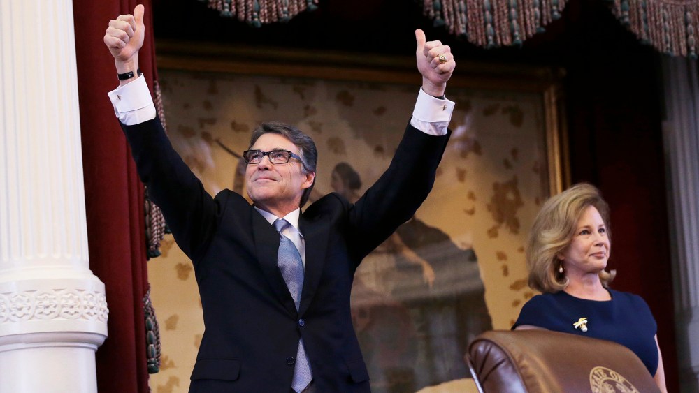 Texas Gov. Rick Perry, left, acknowledges applause next to his wife, Anita, before giving a farewell speech to a joint session of the Texas Legislature, Jan. 15, 2015, in Austin, Texas. (Photo by Eric Gay/AP)