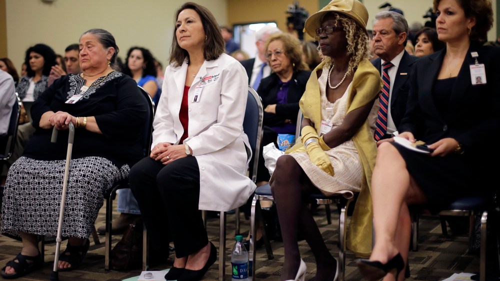 Audience members listen to Health and Human Services Secretary Kathleen Sebelius