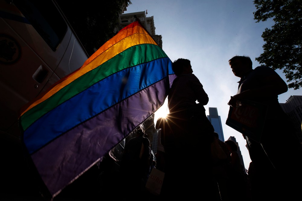 A person holds a flag during a rally at City Hall, Tuesday, May 20, 2014, in Philadelphia, Pa.