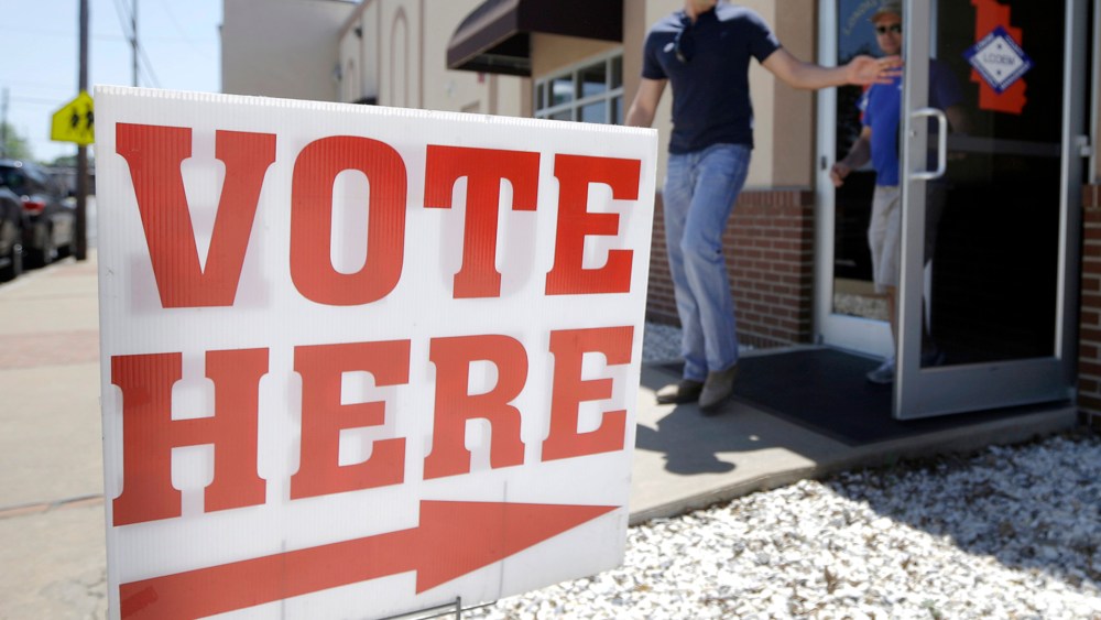 Trey Petrus of Carlisle, Ark., leaves an early voting poling place in Lonoke, Ark., May 5, 2014.