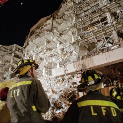 Fire personnel gather at the base of the Alfred P. Murrah Federal Building in downtown Oklahoma City, April 20, 1995, one day after the fatal car bombing.