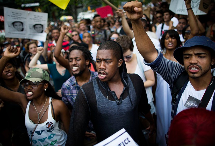Crowds of demonstrators prepare to march towards Times Square, Sunday, July 14, 2013, during a protest against the acquittal of neighborhood watch member George Zimmerman in the killing of 17-year-old Trayvon Martin in Florida. (Photo by John Minchillo...