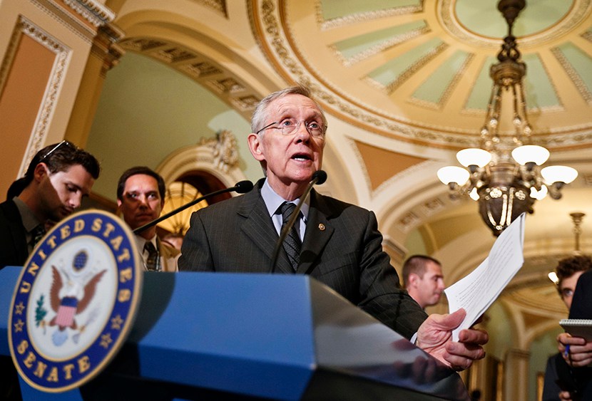 Senate Majority Leader Harry Reid of Nev. gestures as he speaks with reporters, on  Capitol Hill in Washington, Tuesday, July 30, 2013, after a Democratic strategy session. (Photo by J. Scott Applewhite/AP)
