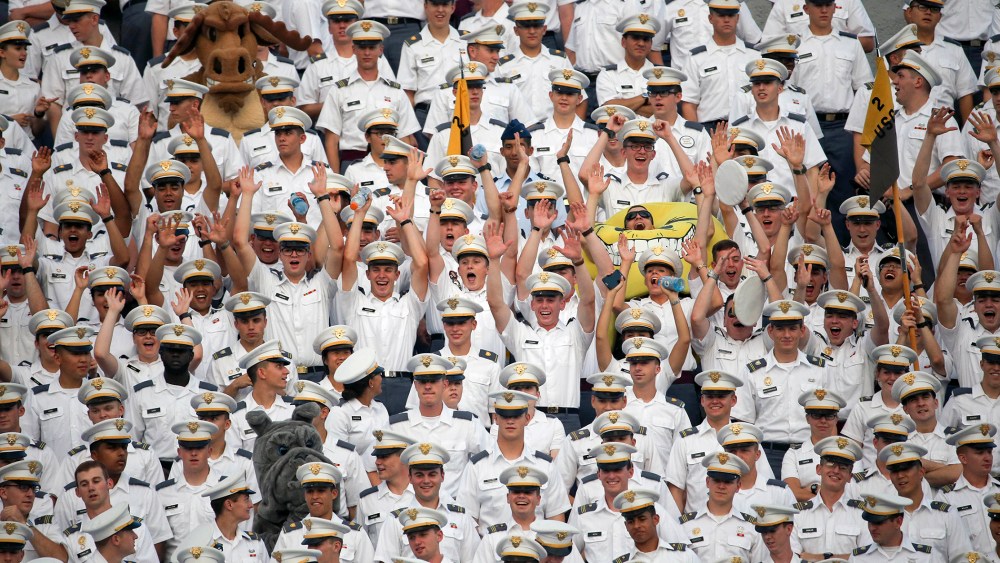 Cadets cheer during the first half of an NCAA college football game between Army and Fordham in West Point, N.Y. More than a dozen students were injured during the annual pillow fight by first year cadets on Aug. 20, 2015. (Photo by Mike Groll/AP)