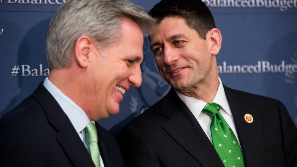 House Budget Committee chairman Paul Ryan whispers to House Majority Whip Kevin McCarthy during the House Republican leadership media availability after the House Republican Conference meeting, March 19, 2013. (Photo By Bill Clark/CQ Roll Call/AP)