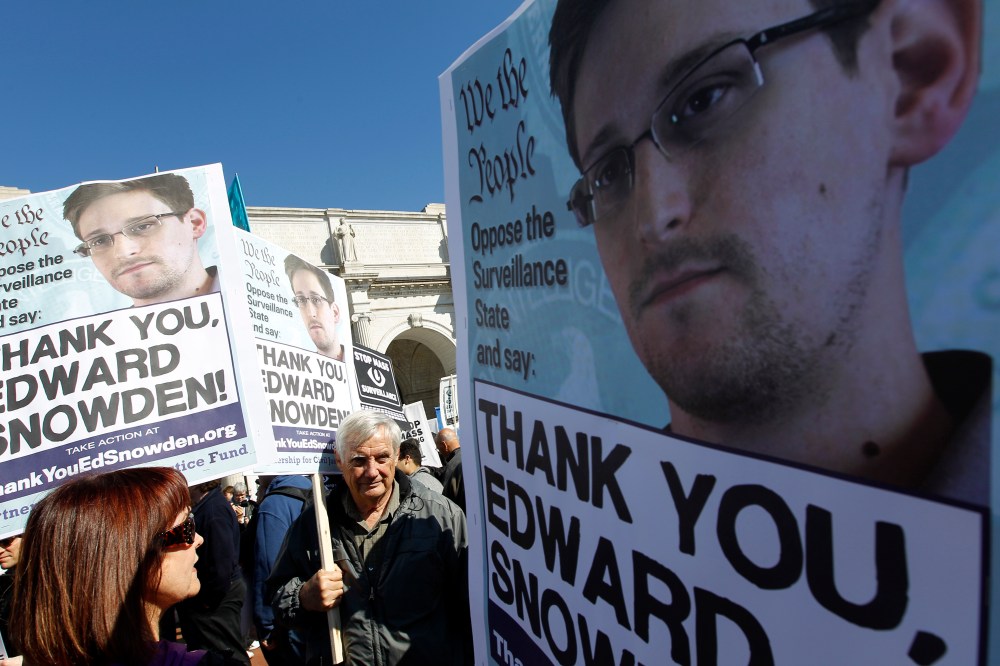 Demonstrators holds up banners with the photo of Edward Snowden during a protest outside of the U.S. Capitol in Washington, on Saturday, Oct. 26, 2013.