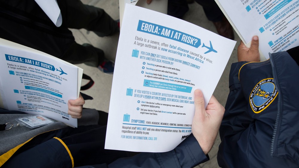 Members of the Brooklyn Borough President's office hand out fliers detailing the risks of Ebola on Oct. 24, 2014. (John Minchillo/AP)
