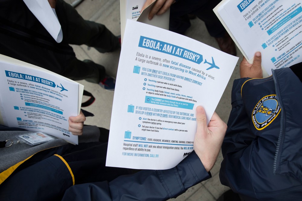 Members of the Brooklyn Borough President's office hand out fliers detailing the risks of Ebola on Oct. 24, 2014. (John Minchillo/AP)