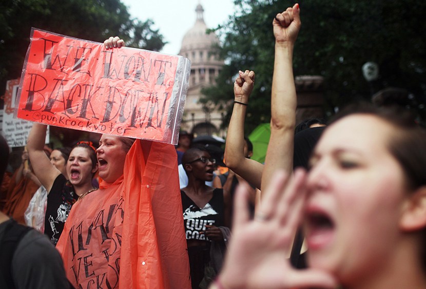 Hundreds of abortion rights demonstrators rally outside of the State Captiol to protest recent legislation that could shut down all but five clinics and restrict abortion rights throughout the state in Austin, Texas on Monday, July 15, 2013. (Photo by...