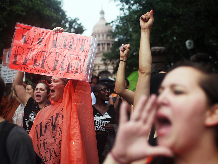 Hundreds of abortion rights demonstrators rally outside of the State Captiol to protest recent legislation that could shut down all but five clinics and restrict abortion rights throughout the state in Austin, Texas on Monday, July 15, 2013. (Photo by...
