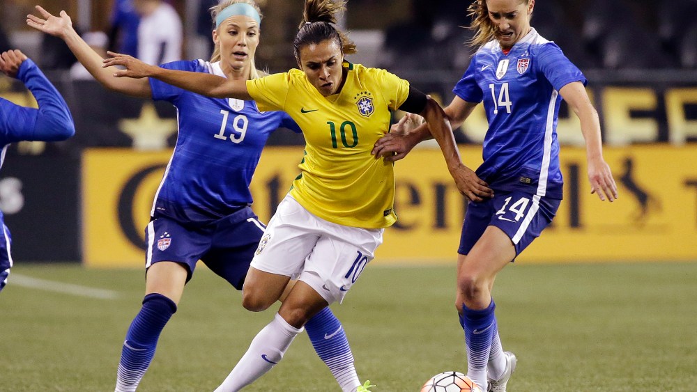 Brazil's Marta (10) works to get to the ball between the United States' Julie Johnston (19) and Morgan Brian (14) during the first half of an international friendly soccer match, Oct. 21, 2015, in Seattle. (Photo by Elaine Thompson/AP)