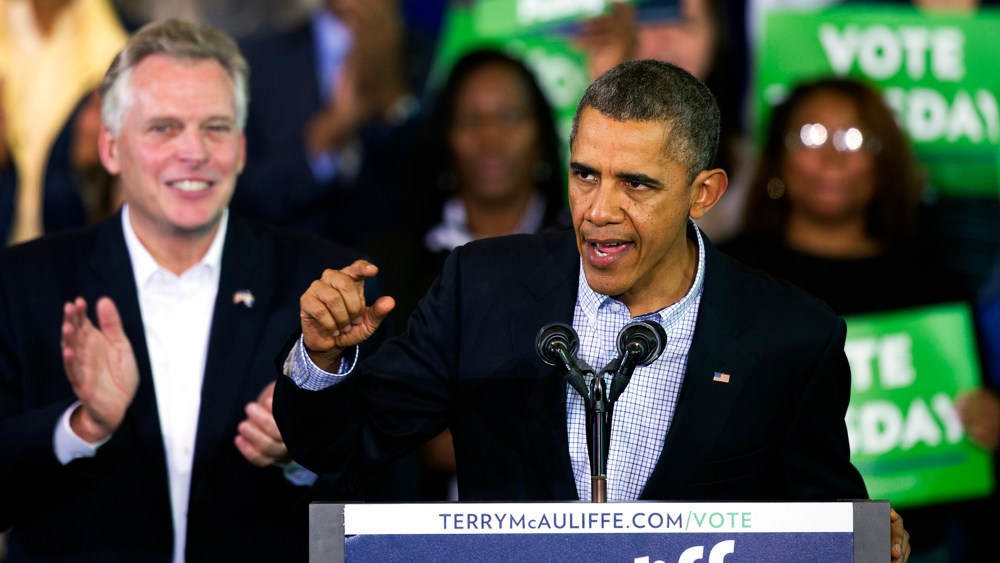 President Barack Obama speaks at a campaign rally with supporters for Virginia Democratic gubernatorial candidate Terry McAuliffe, right, at Washington Lee High School in Arlington, Va., Sunday, Nov. 3, 2013.