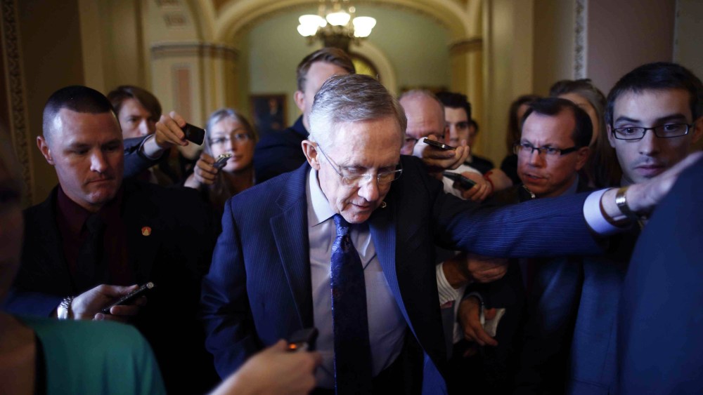 Senate Majority Leader Harry Reid of Nevada leaves the Senate floor to meet with Democratic Senators on Capitol Hill in Washington Saturday, Oct. 12, 2013.