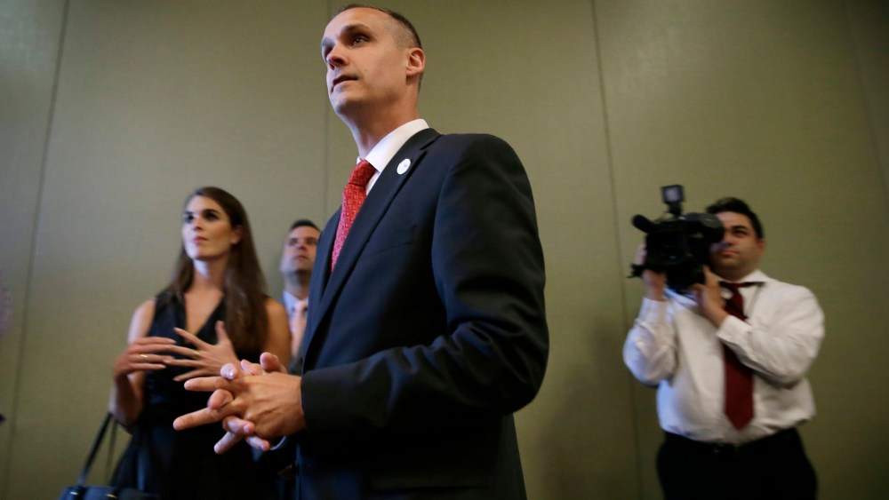 In this photo taken Aug. 25, 2015, Republican presidential candidate Donald Trump's campaign manager Corey Lewandowski watches as Trump speaks in Dubuque, Ia. (Photo by Charlie Neibergall/AP)