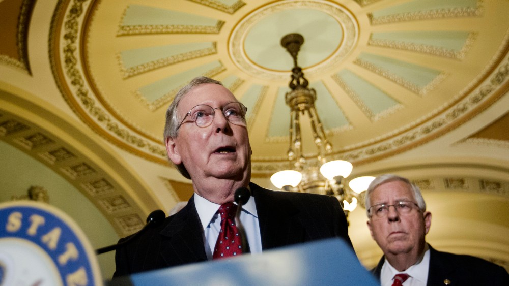Senate Majority Leader Mitch McConnell of Ky., accompanied by Sen. Mike Enzi, R-Wyo., speaks to reporters on Capitol Hill in Washington, March 24, 2015. (Photo by Pablo Martinez Monsivais/AP)