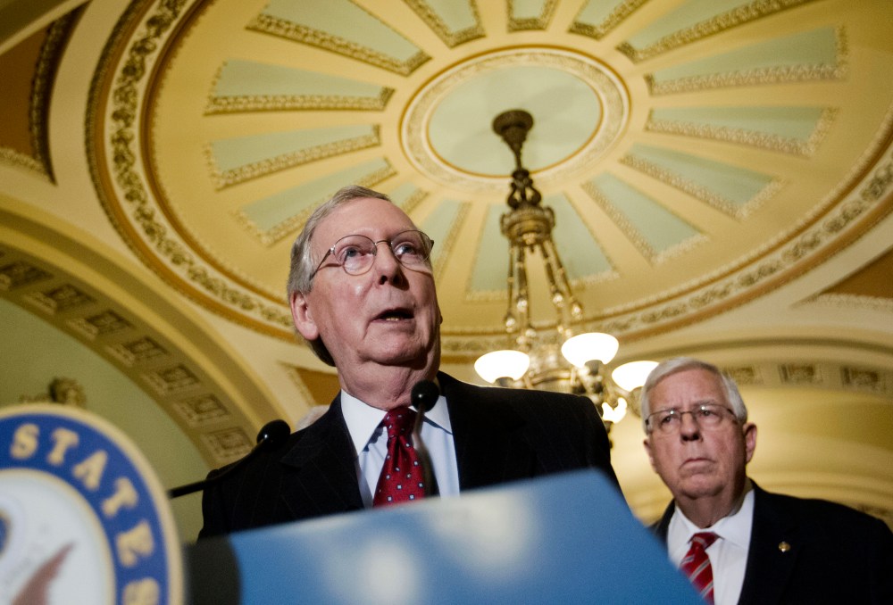 Senate Majority Leader Mitch McConnell of Ky., accompanied by Sen. Mike Enzi, R-Wyo., speaks to reporters on Capitol Hill in Washington, March 24, 2015. (Photo by Pablo Martinez Monsivais/AP)