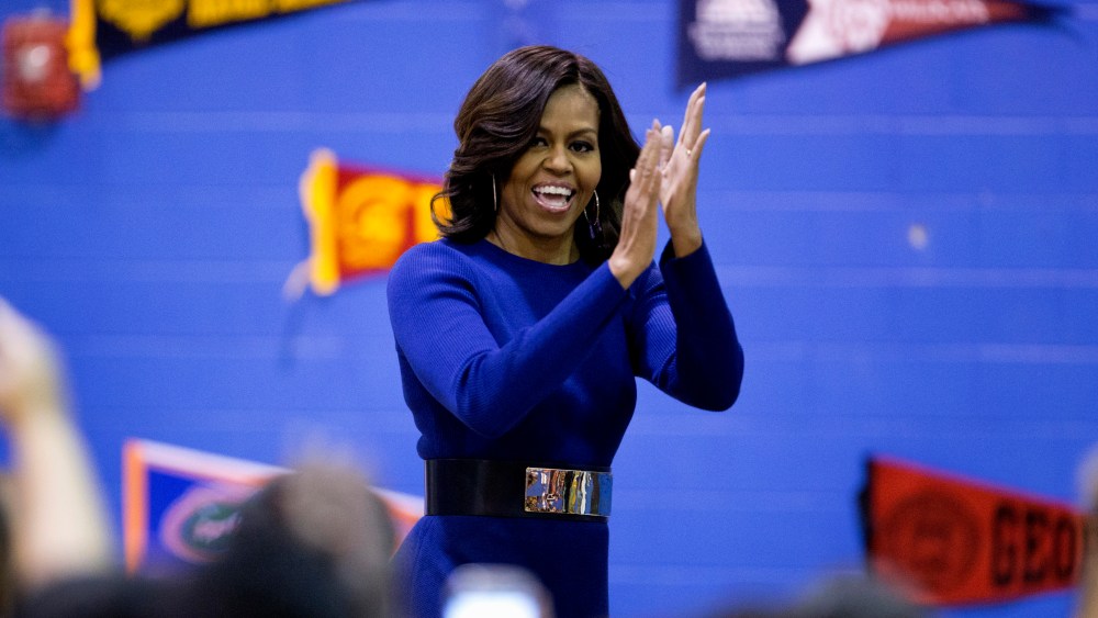 First lady Michelle Obama arrives to speak at Capital City Public Charter School in Washington, Dec. 5, 2014, during the second annual College Application March, part of her Reach Higher initiative. (Photo by Carolyn Kaster/AP)