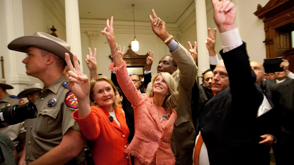 State Senators, from second left, Sylvia R. Garcia, D-Houston, Wendy Davis, D-Fort Worth, Royce West, D-Dallas, Kirk Watson, D-Austin, and John Whitmire, D-Houston,  greet abortion rights advocates to show they voted against HB2, which the Senate approved
