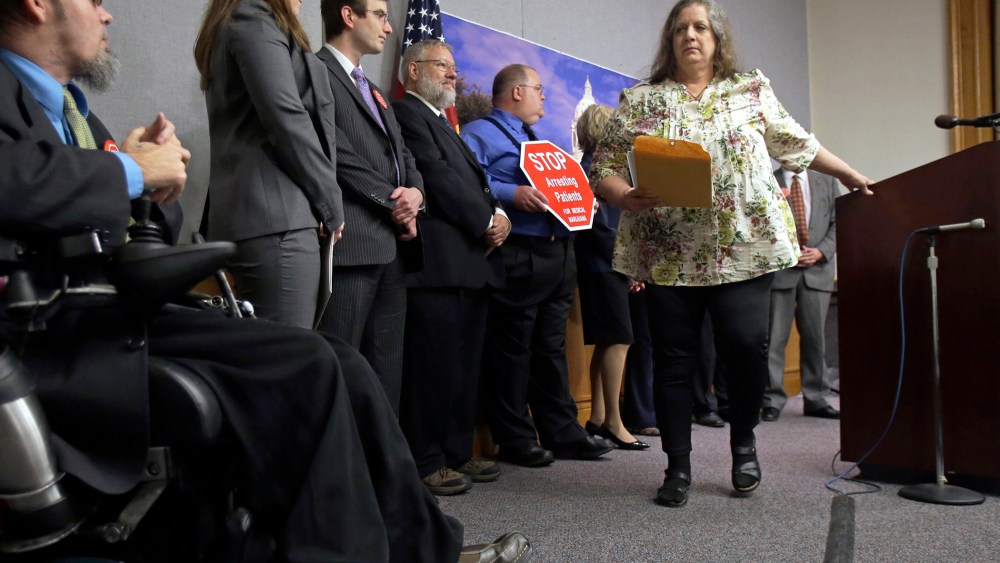 Joni Whiting, right, of Jordan, Minn., leaves the podium after encouraging support of a bill to legalize medical marijuana in Minnesota during a State Capitol news conference on May 2, 2013 in St. Paul, Minn.