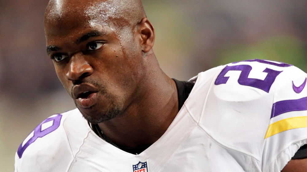 In this Sept. 7, 2014, file photo, Minnesota Vikings running back Adrian Peterson warms up for an NFL football game in St. Louis, Mo. (Photo by Tom Gannam/AP)