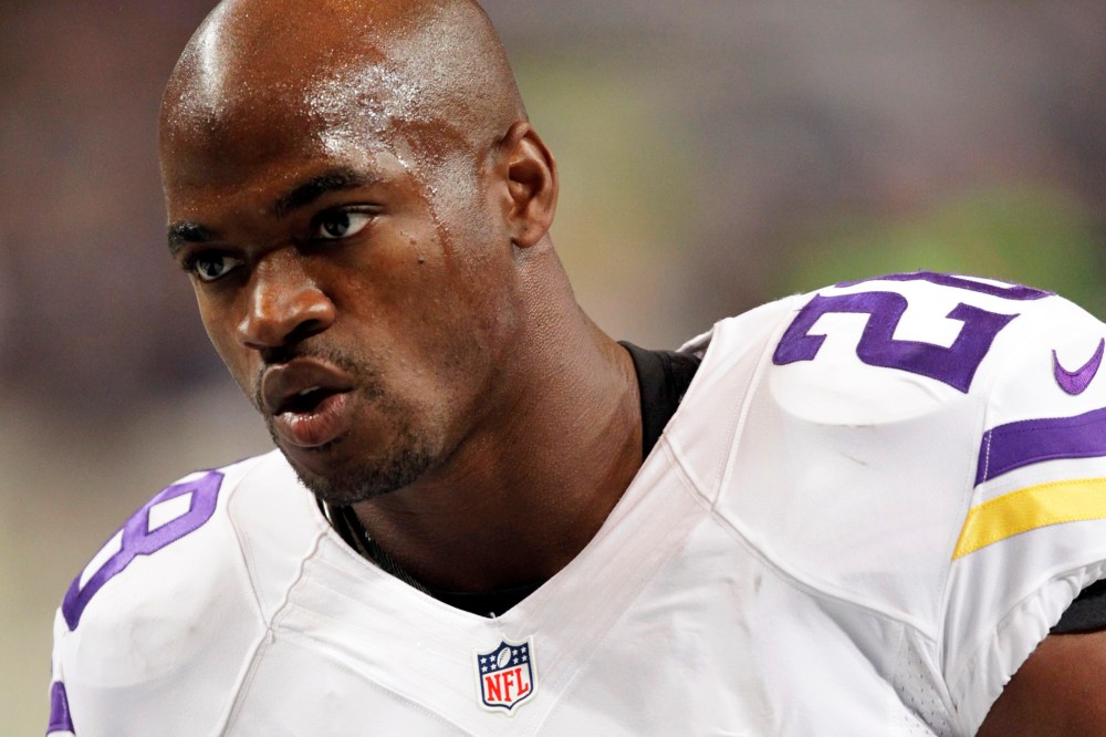 In this Sept. 7, 2014, file photo, Minnesota Vikings running back Adrian Peterson warms up for an NFL football game in St. Louis, Mo. (Photo by Tom Gannam/AP)