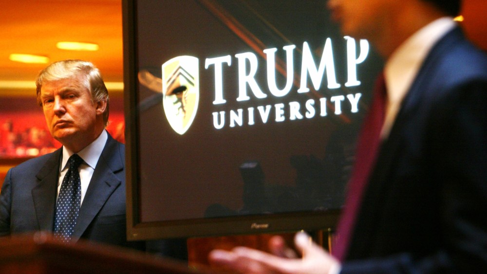 Real estate mogul and TV star Donald Trump listens as Michael Sexton introduces him to announce the establishment of Trump University at a press conference in New York, May 23, 2005. (Photo by Bebeto Matthews/AP)