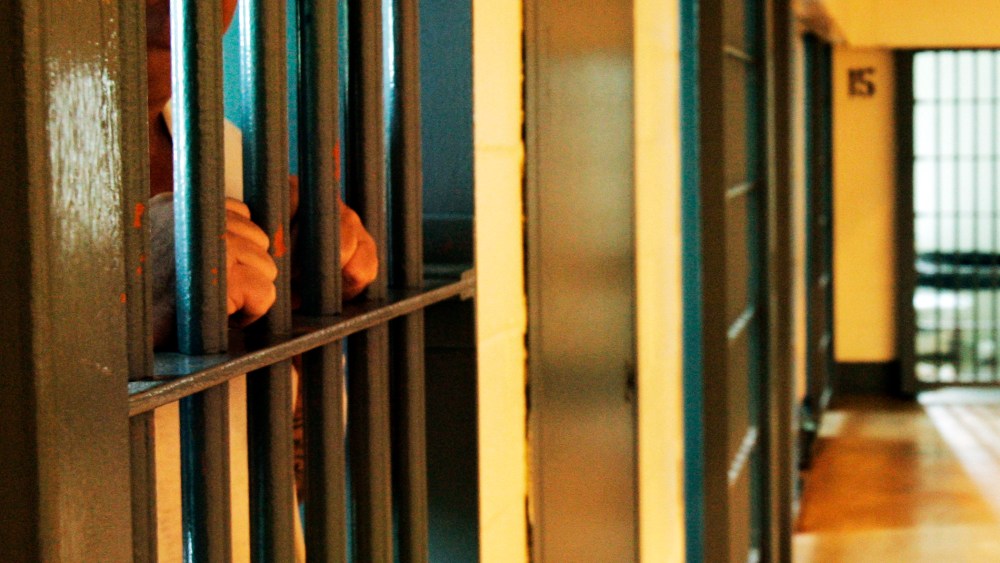 An inmate stands by his cell door. (Photo by Danny Johnston/AP)