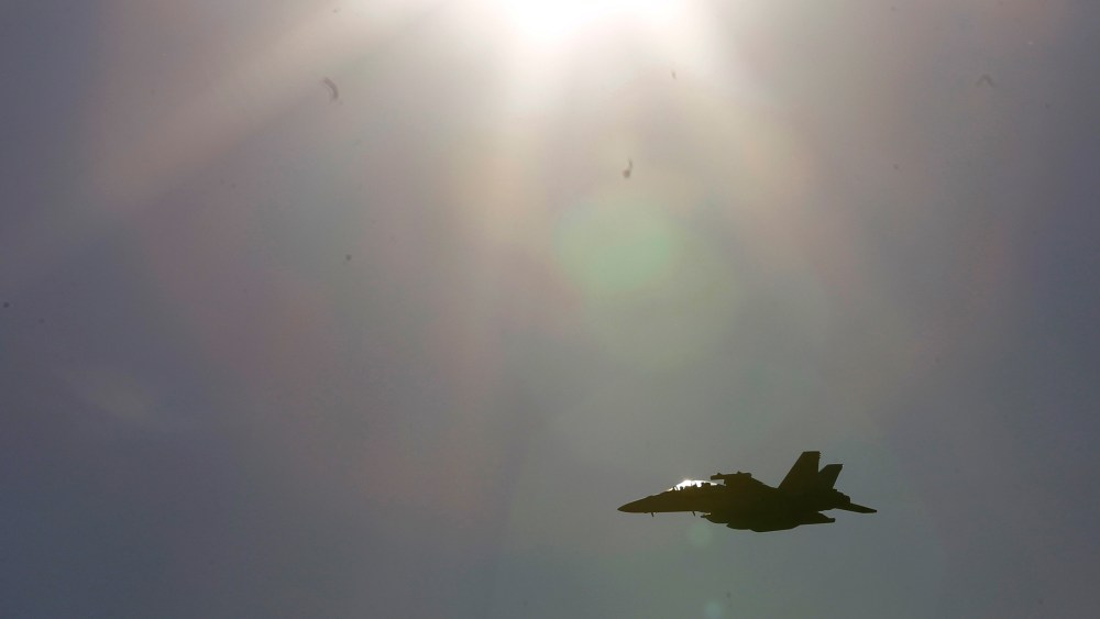 Pictured, an F-18 jet fighter jet. (Photo by Luca Bruno/AP)