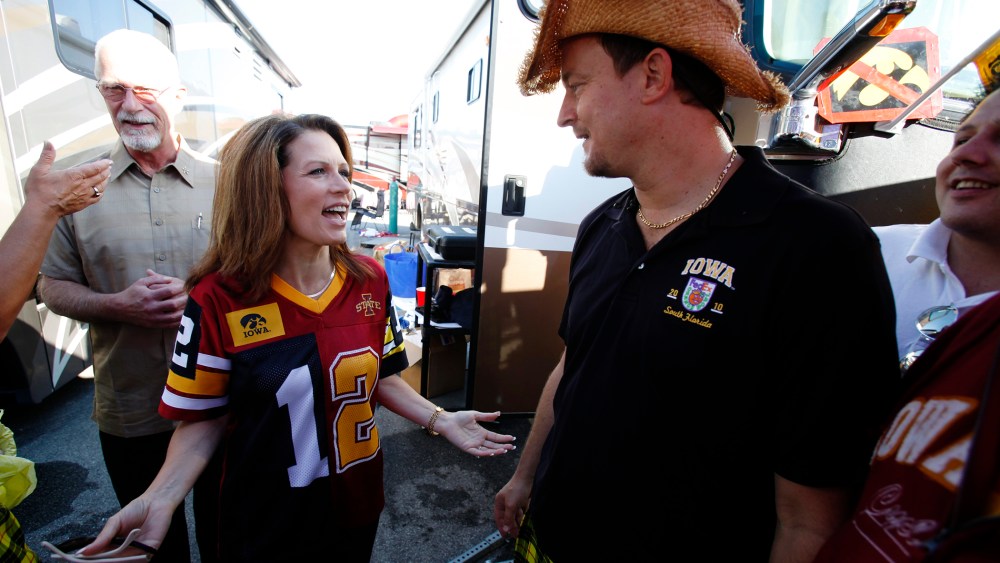 Former U.S. Rep. Michele Bachmann talks with Mark Chelgren of Ottumwa, Iowa, while tailgating before an NCAA college football game between Iowa State and Iowa, Sept. 10, 2011, in Ames, Iowa. (Photo by Charlie Neibergall/AP)