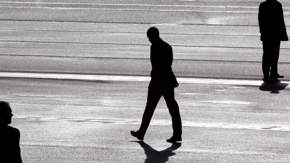 President Barack Obama, center, and two secret service agents are silhouetted as he walks towards Marine One helicopter upon arrival at Schiphol Amsterdam Airport, Netherlands March 24, 2014. (Photo by Peter Dejong/Pool/AP)