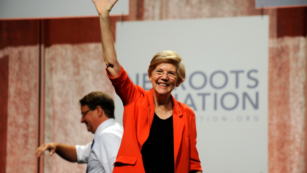 U.S. Sen. Elizabeth Warren, D-Mass., waves to the crowd after her introduction at the Netroots Nation conference in Detroit (Photo by David Coates/AP).